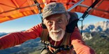 Senior man hang gliding clear sky mountainous background expression of freedom and exhilaration