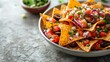 A plate of Mexican nachos served with both salsa and guacamole, showcasing a vibrant array of vegetables, chicken, and spices This delicious dish is a blend of Thai-inspired flavors, featuring green a
