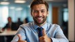 Smiling businessman showing thumbs up in the office