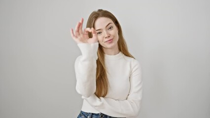 Poster - Cheerful young woman in sweater gesturing an excellent ok sign, radiating positivity against a white background