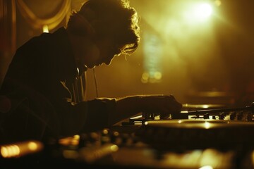 Poster - A man playing a DJ mixer in a dimly lit room. Ideal for music production concept
