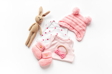 Wall Mural - Set of baby girl dress - bodysuit with knitted hat and boots, top view. Kids clothing flat lay