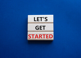 Wall Mural - lets get started symbol. concept words lets get started on wooden blocks. beautiful deep blue backgr