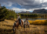 Cowboy cowgirl couple trail riding colorado wilderness autumn fall mountain  lake