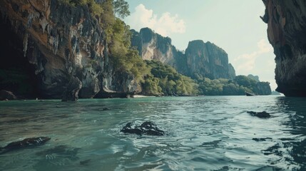 Poster - Scenic view of a body of water with rocks and trees in the background. Suitable for nature and travel concepts