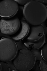 Poster - A bunch of black buttons stacked on top of each other. Suitable for fashion or crafting projects