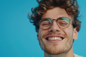 Poster - A man with curly hair and glasses smiling. Suitable for various concepts