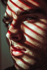 Poster - Close up of a man's face with sunlight shining through blinds. Perfect for lifestyle and wellness concepts