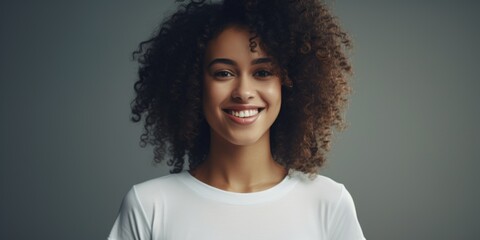 Poster - A woman with curly hair smiling at the camera. Suitable for various marketing materials