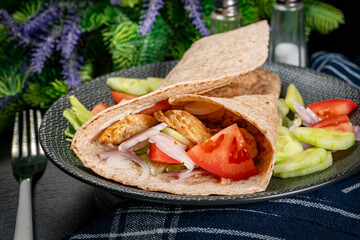 Canvas Print - Wholegrain tortilla wraps with vegetables and chicken on a plate.