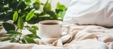 Fototapeta Kuchnia - A cup of coffee is placed on top of a neatly made bed in an abstract white and colored gradient glasses interior with a window in the background.