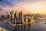 Fototapeta  - Panoramic view of the modern skyline of Dubai Marina with skyscrapers reflecting the warm sunset sunlight, United Arab Emirates