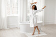 © Home-stock - Happy african american lady dancing having fun enjoying morning beauty care routine in bathroom, full length shot, free space