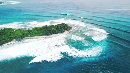 Poster - Aerial view of the tropical island surrounded by breaking waves in the Maldives