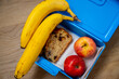 Morning essentials neatly packed for a day at school or the office: Banana, apples, and banana bread for a quick snack.