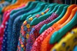 A vibrant array of colorful dresses hanging neatly on a rack in a boutique.