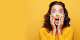 Fototapeta  - Shocked lady with hands on cheeks, open mouth, wide eyes. Concept of shock, unexpected news, pleasant sale or offer, joyful reaction, promotional content. Yellow backdrop. Wide banner with copy space