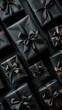 A group of black wrapped presents stacked on top of each other against a dark background.