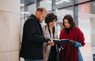 Three professionals in stylish winter attire engaged in outdoor meeting.