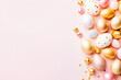 Assorted Peach and Gold Easter Eggs Arranged on Solid Pink Background. Top view