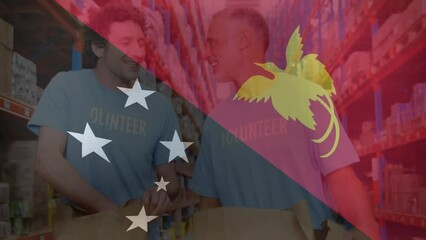 Canvas Print - Animation of flag of papa new guinea over caucasian male volunteers high fiving in warehouse