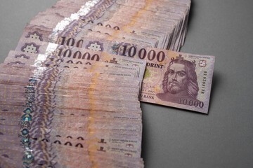 Wall Mural - Hungarian banknote bundle money (forint) 10,000 HUF banknotes spread out on a table, close-up as background. Europe Hungary.