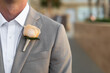 A boutonnière is a floral decoration, typically a single flower or a single stick, worn on the lapel of a tuxedo or suit jacket.