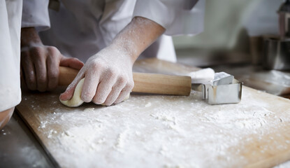 Wall Mural - kneading bread dough by hand