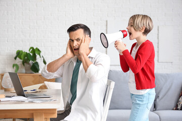 Sticker - Working young man stressed of his noisy little son shouting into megaphone at home