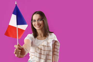 Canvas Print - Beautiful young woman with flag of France on purple background