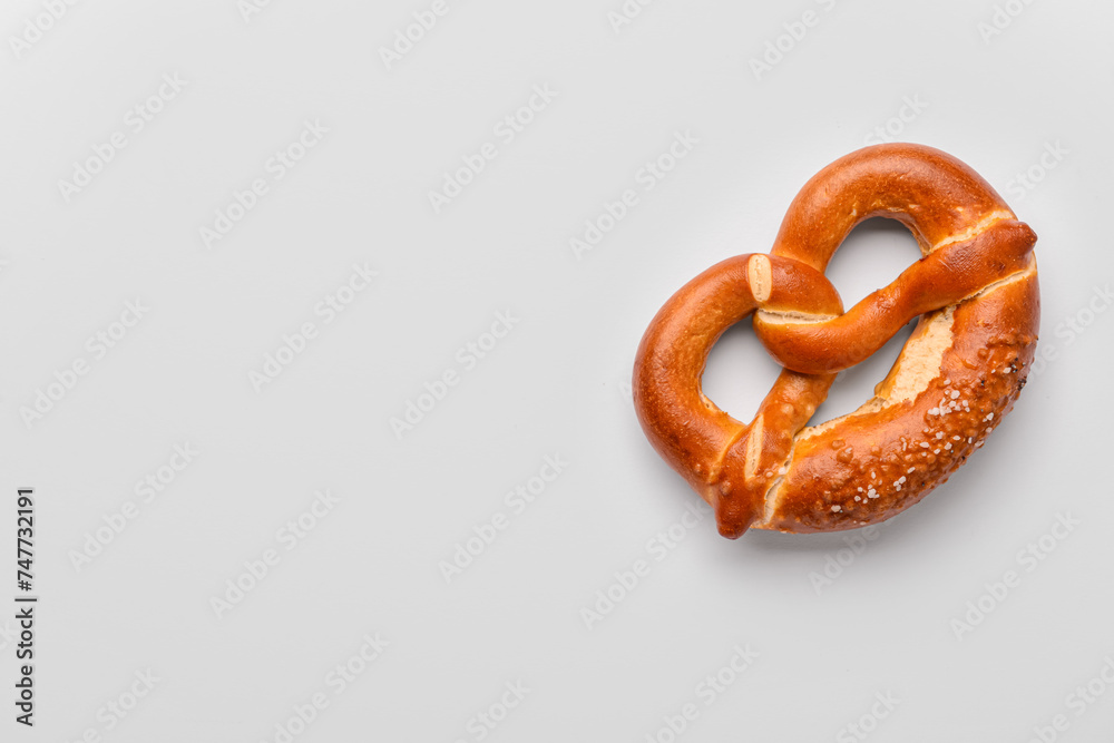 Fresh delicious pretzel on white background