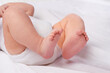 © T. Rose/peopleimages.com - Closeup, newborn baby or feet for relax, bed and nap for healthy childhood, care and development. Bare foot, leg and toes of young child for calm, rest and sleeping in peaceful nursery for dreaming
