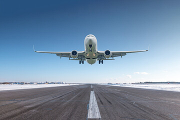 Wall Mural - White passenger airliner take off airport runway at winter