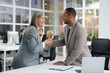 © New Africa - Lawyer shaking hands with client in office, selective focus