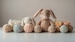 Pastel colored yarn and cozy handmade stuffed animals on a soft neutral background, perfect for creative craft projects or nursery decor