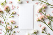 © lucky pics - White greeting card with flowers mock up high angle view directly above decoration. Neural network generated image. Not based on any actual scene or pattern.