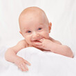 © T. Rose/peopleimages.com - Studio, playful and baby in white background, portrait and face of innocent infant, youth and adorable. Young child, cute and healthy with skincare, soft and toddler with glow, shine and closeup