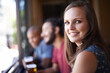 Portrait, happy and a woman at pub to relax, cheerful or positive facial expression for leisure at restaurant tavern. Face, bar and smile of young female person or casual customer at cafe for alcohol