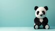 3D rendering of a cute and fluffy panda sitting on a blue background. The panda has a friendly expression on its face and is looking at the camera.