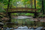 Fototapeta Pomosty - A wooden bridge spans a flowing stream, nestled in the heart of a lush forest, Rustic wooden bridge crossing a quiet creek, AI Generated