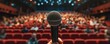 Speech Time concept. Microphone with blured auditorium in background.