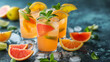 several glasses of fresh frozen lemon juice with pieces of orange and grapefruit, summer refreshing lemonade