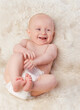 © T. Rose/peopleimages.com - Baby, cute and laugh in bedroom, blanket and playtime in diaper for child development in happiness. Infant, kid and wellness for newborn, adorable and rug in house for home and toddler fun
