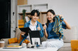 © Nuttapong punna - Fashion blogger concept, Two Asian women selling clothes on video streaming.Startup small business SME, using smartphone or tablet taking receive and checking.