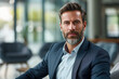 © boxstock production - Charismatic professional businessman with beard wearing modern suit in modern office environment