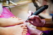 close up of a hands making pedicure polish on the table in spa salon