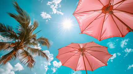 Wall Mural - tropical palm trees and pink umbrellas on sky background