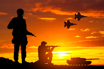 Wall Mural - Silhouettes of a soldiers with main battle tank and military airplanes against the sunset