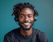 Smiling young african american man with dreadlocks wearing headphones