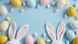 A festive Easter composition featuring whimsical bunny ears and an assortment of pastel-colored eggs scattered on a soft blue background